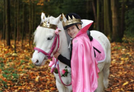 Bild eines Kindes als Prinzessin verkleidet mit einem Pony
